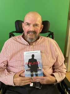 Tim Goddard with copy of novel Found